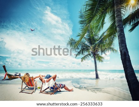 Couple on the beach at tropical resort Travel magazine concept