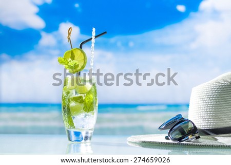 Mojito cocktail with fresh lime at the beach