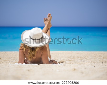 Woman relaxing on the famous Shipwreck Navagio beach in Zakynthos Greece
