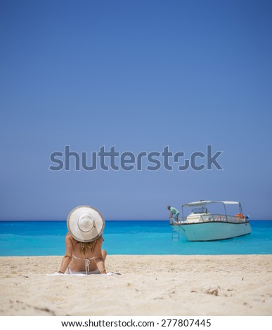 Woman relaxing on the famous Shipwreck Navagio beach in Zakynthos Greece