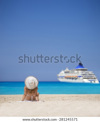 Woman relaxing on the famous Shipwreck Navagio beach in Zakynthos Greece watching a cruiseship passing by