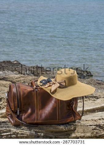 Vintage leather travel bag on the beach