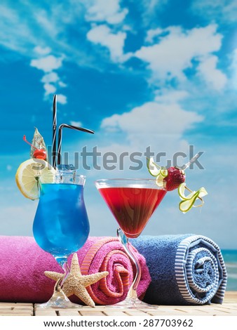 Blue lagoon and strawberry daiquiri cocktails on the beach