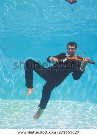 Aquatic music underwater violinist in suit