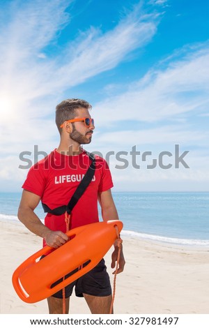 lifeguard on duty keeping a buoy at the beach