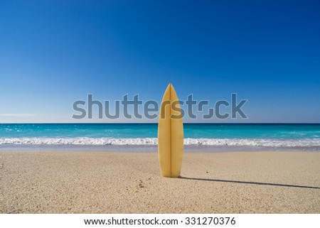 Surfboard on the beach  awaiting fun in the sun