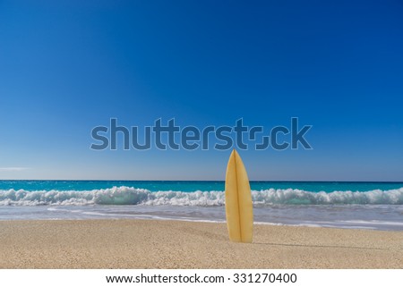 Surfboard on the beach  awaiting fun in the sun
