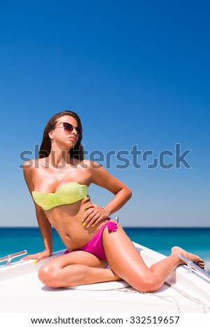 Beautiful girl relaxing on a speed boat