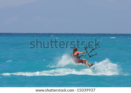 kite boarder riding the waves  on a sunny day