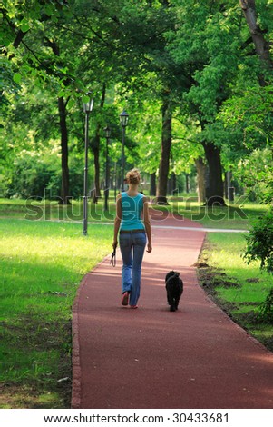 girl and her dog walking in the countryside