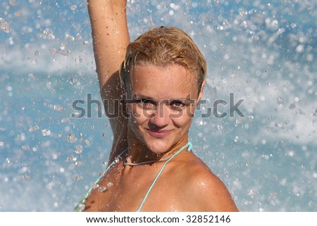 Pretty blonde woman enjoying a swimming pool in Greece