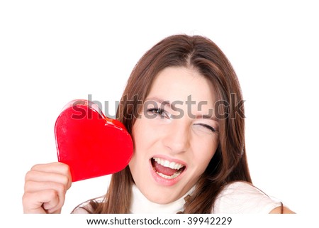 Portrait of a attractive young woman holding a red heart over white background