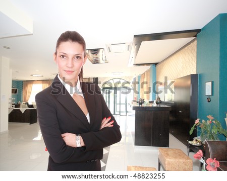 Young Attractive brunette Receptionist, At A Hotel Check In