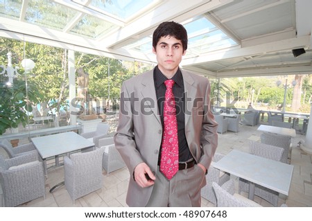 A handsome male hotel manager in the hotel restaurant