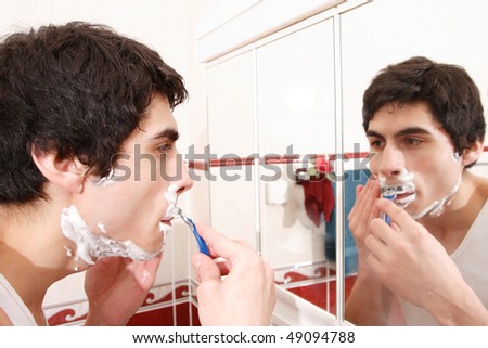 morning routine: a man shaving before going to work