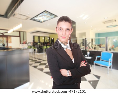 Young Attractive brunette Receptionist, At A Hotel Check In