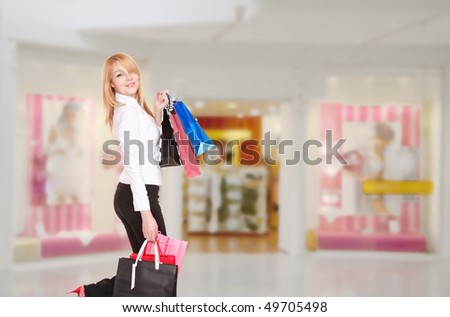 Close-up of young woman with shopping bags  in the shopping mall