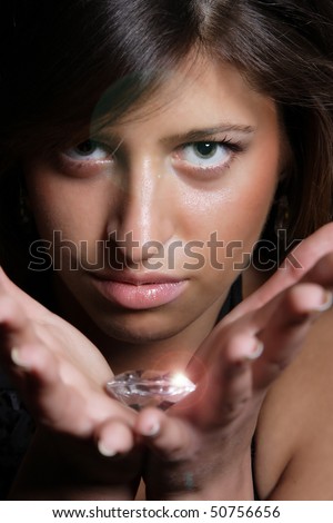 Beautiful girl holding a big diamond in her hand