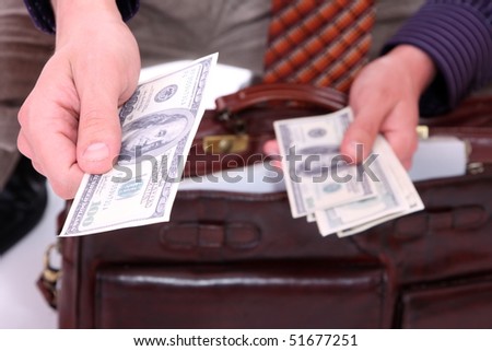 money in a businessman hands over white background
