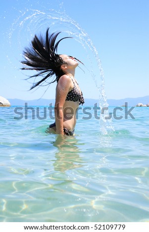Happy young woman in sea in greece