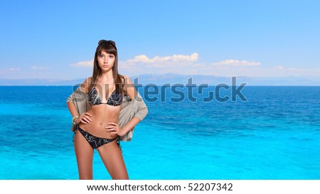 beautiful young bikini model with sea on background