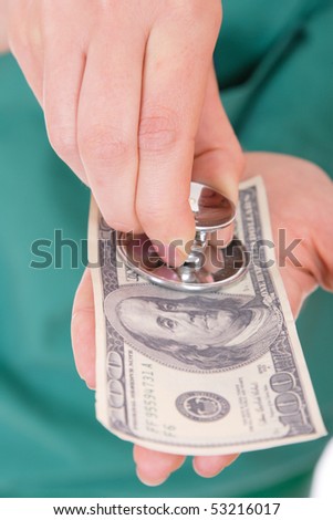 A one hundred dollar bill and stethoscope