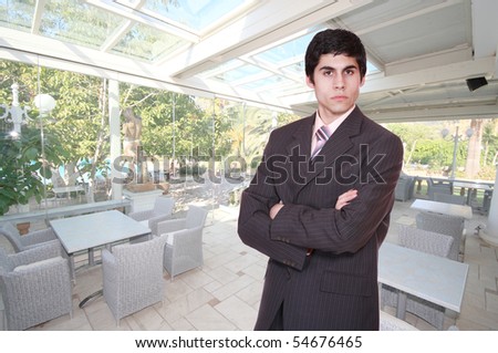 A handsome male hotel manager in the hotel restaurant