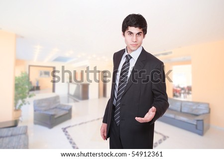 A handsome male hotel manager in the lobby