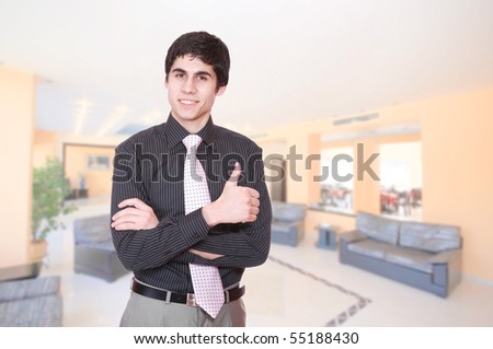 A handsome male hotel manager in the lobby