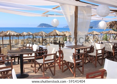 Кафенето.. Stock-photo-cafe-on-the-beach-in-greece-59141404
