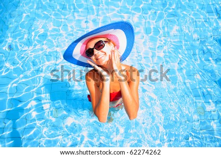 Beautiful young sexy woman by a swimming pool  in Greece