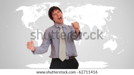 Young attractive businessman with world map in background