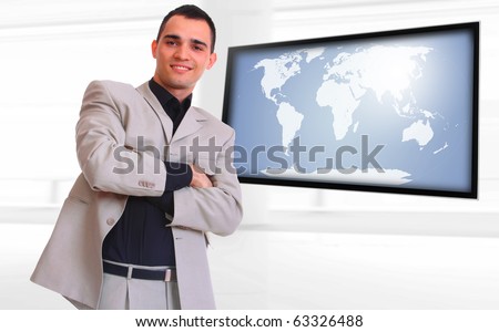 Happy business man presenting with world map on flat screen TV - Globalization