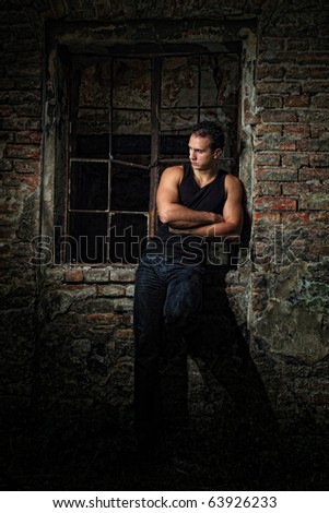 Young muscular sexy male model against retro vintage outdoor background