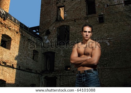 Young muscular sexy male model against retro vintage outdoor background