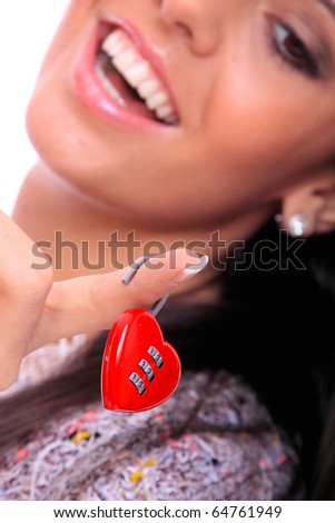 Portrait of a beautiful young woman holding a red heart shaped lock isolated over white background
