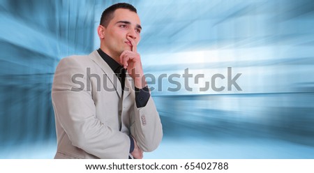 An attractive business man thinking  in a light business environment