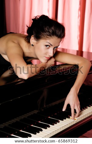 A beautiful young woman playing piano