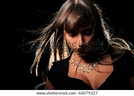 Attractive young fashion model over black background