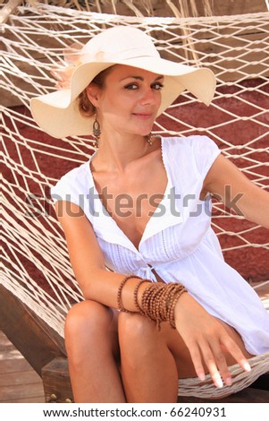 Woman sitting on sun bed in the summertime