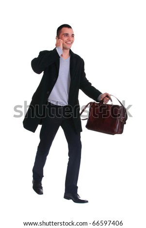 Portrait of a successful young business man on the phone carrying a suitcase on white background