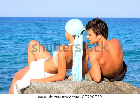 Young beautiful couple watching the sea