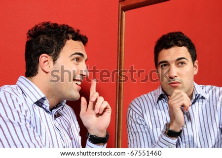 One man, with two faces on the mirror over red background