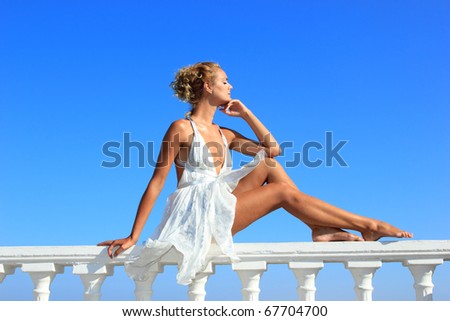 Beautiful fashion woman by the sea in Greece