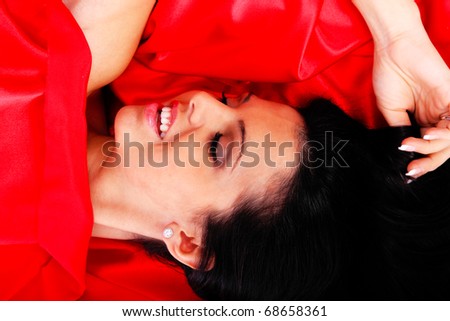 beautiful young woman in red long dress laying on the floor