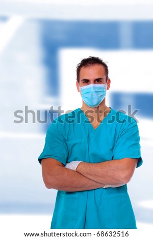 Handsome male doctor posing over light medical environment background