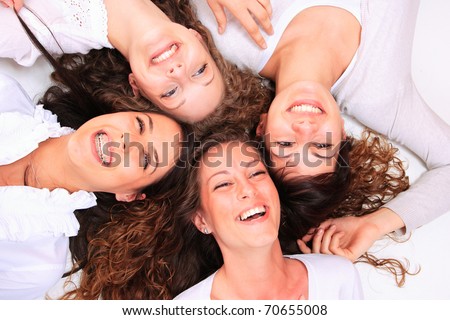 Group of happy pretty laughing girls over white background