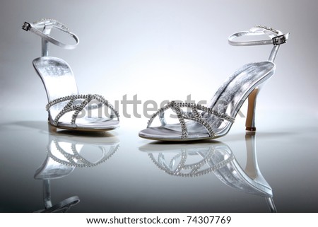 stock photo Elegant wedding shoes over gradient gray background