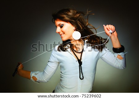 Beautiful Girl with headset  listening music with her cell phone