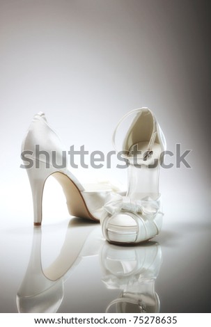 stock photo Elegant wedding shoes over gradient gray background